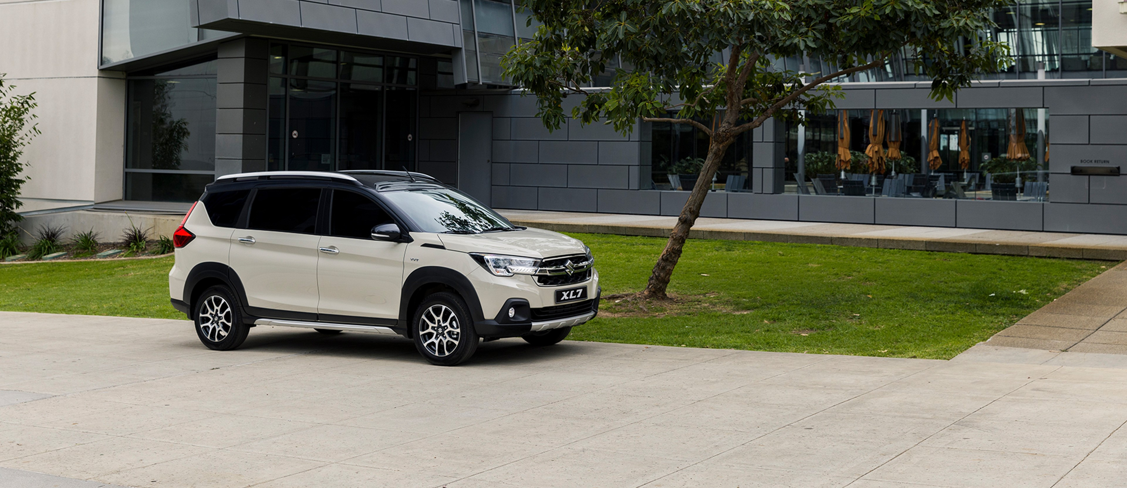 Suzuki XL7 GL parked outside an office building